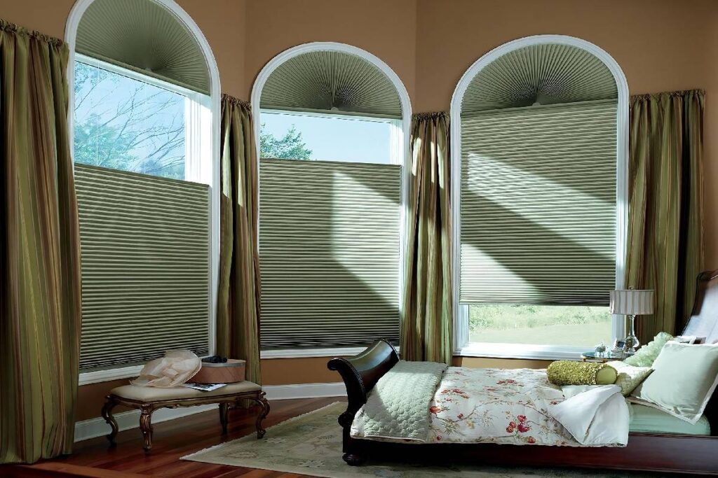 Elegant bedroom decorated with green Hunter Douglas Duette® Cellular Shades