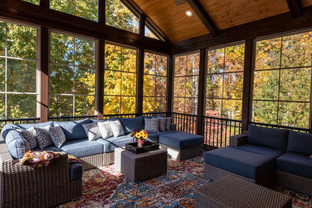 A fall outdoor area rug in a sunroom with furniture and a view of changing leaves at Phillips Paint and Decorating Center near Lancaster, PA