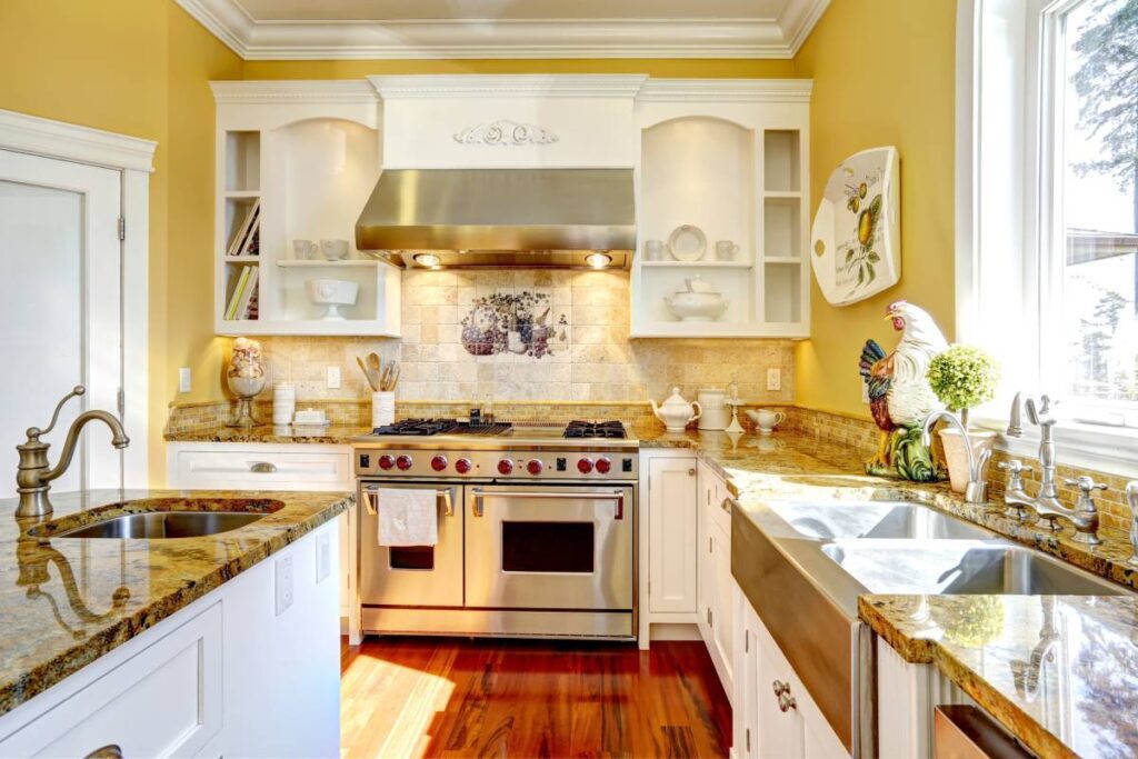 Kitchen with granite countertops and bright yellow walls, similar to Benjamin Moore Jasper Yellow 2024-50 at Phillips Paint & Decorating near Lancaster, PA